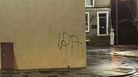 Man arrested after graffiti sprayed near Troubles memorial