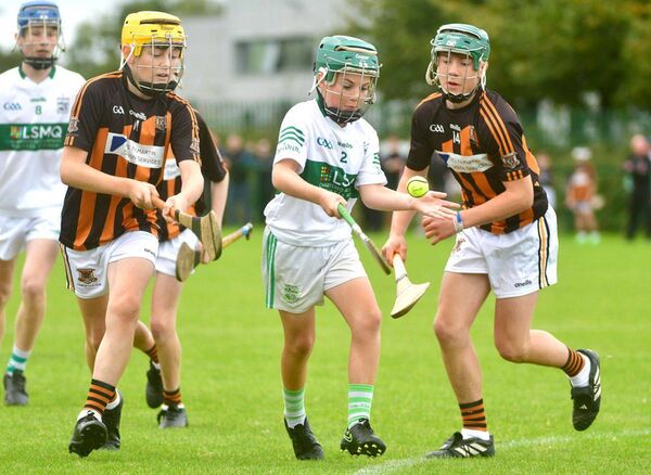 Portlaoise's Tadhg Bohan looking to release this ball as Lee Bredin and Ryan Guilfoyle keep close Photo: Denis Byrne