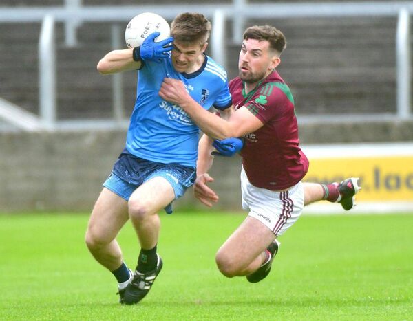 Martin Scully (Ballyroan Abbey) looking to control this ball as Portarlington's Keith Bracken challenges Photo: Denis Byrne