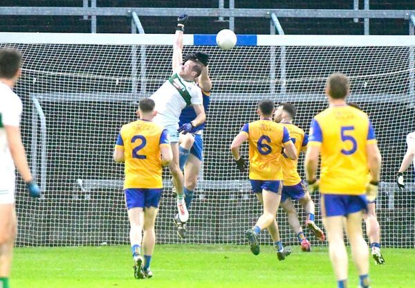 Kieran Lillis makes contact with this ball to beat Enda Butler and score Portlaoise's first goal in their SFC quarter-final win over St Joseph's at Laois Hire O'Moore Park on Saturday Photo: Denis Byrne