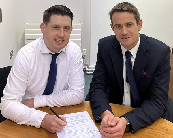 Jason Lynch signing the nomination paper overseen by the General Election Returning Officer for the Laois Constituency Rory Hanniffy. 
