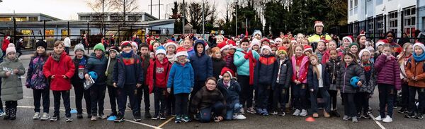 Pupils from Gaelscoil Phortlaoise with Garda SAran Grehan who took part iin the Santa Stroll around Portlaoise. Photo: Rene PR Design