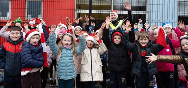 Community Garda Ronan Maher with just some of the pupils who took part in the Santa Stroll. Photo: Rene PR Design