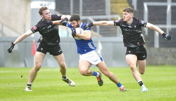 Laois' Danny O'Reilly drives past Sligo's Ross Doherty and Lee Deignan in their NFL meeting on Sunday at Laois Hire O'Moore Park              Photo: Denis Byrne