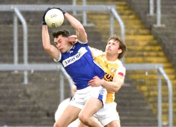Mark Barry wins possession for Laois despite Antrim's Jack Morgan challenging Photo: Denis Barry