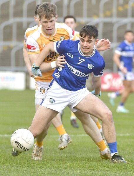 Laois's Ben Dempsey holds off Antrim's Ryan McQuillan in Laois Hire O'Moore Park on Sunday Photo: Denis Byrne