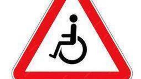 Sign and road markings indicating presence of wheelchair users for Laois village