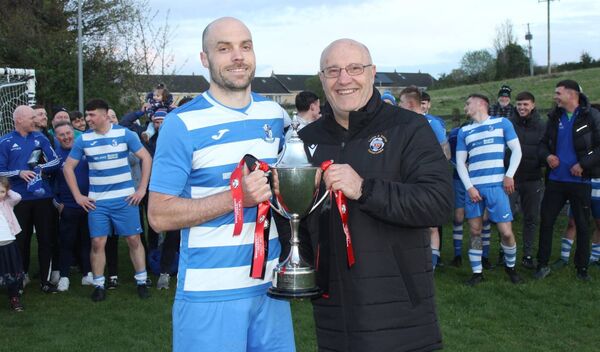 St Fiacc's captain Bobby Dowling receives the Tully Travel Division 1 trophy