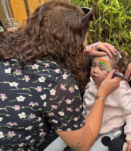 Putting the finishing touches to one of the many young people who were at the day ling Gig for Gaza by LOL face Painting
