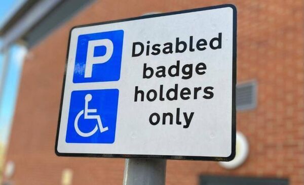 A Portlaoise councillor has called for a text number to be placed on disabled parking bay signs so that those illegally parking in the bays could be reported to the traffic wardens to come and deal with the offender.