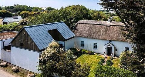 Two homes for the price of one: Thatched cottage and bungalow on sale together