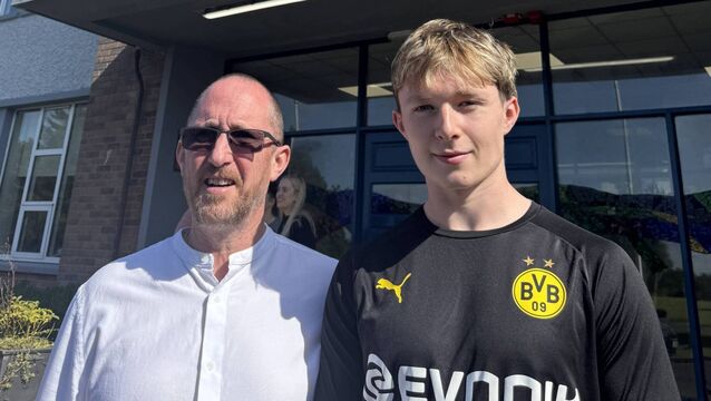 <p>Proud teacher Donnacha O’Siochain is pictured with his son Ruadhan who collected his leaving cert results from Heywood Community School</p>