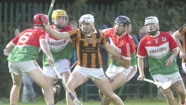 <p>Kevin Byrne (Camross) battles to free himself from the clutches of these Clonaslee/Sy Manman's players in their PIHC quarter-final Photo: Denis Byrne</p>