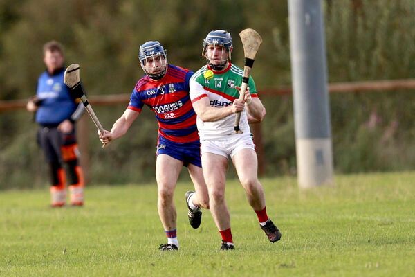 Rathdowney'/Errill's Patrick Hassett looks to get rid of this ball before Brian Guilfoyle (Colt-Shanahoe) get his tackle in Photo: David Maher