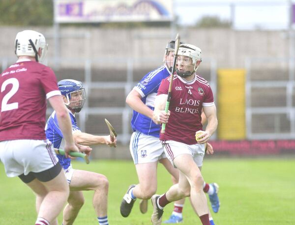 Lir McDonald (Ballinakill) has a quick look before playing this pass against Castletown Photo: Denis Byrne Lir McDonald (Ballinakill) has a quick look before playing this pass against Castletown Photo: Denis Byrne