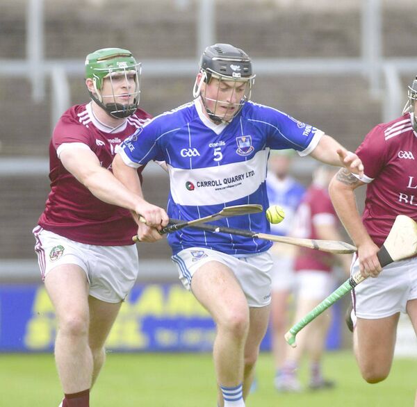 Tommy Goode (Castletown) breaking with Ryan Quinlan (Ballinakill) looking to dispossess him Photo Denis Byrne Tommy Goode (Castletown) breaking with Ryan Quinlan (Ballinakill) looking to dispossess him Photo Denis Byrne