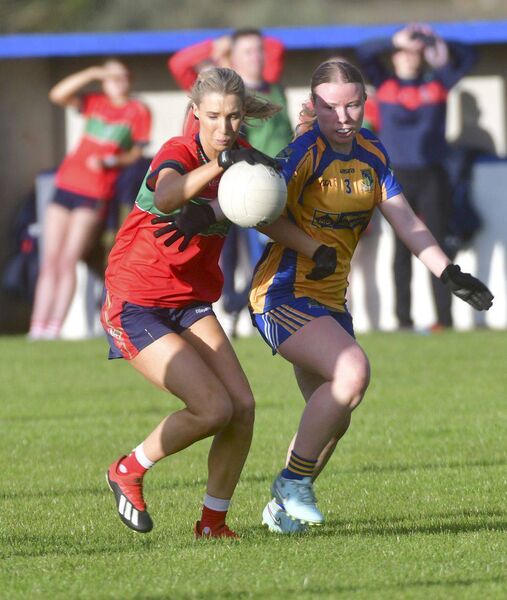 Aishling Quigley (Timahoe) battles with Aoife Hughes (Sarsfields) for possession Photo: Denis Byrne