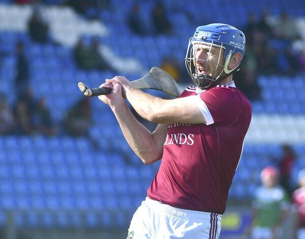 Ballinkill's Eddie Dwyer keeps his eye on the sliotar as he goes for score against Rosenallis Photo: Denis Byrne