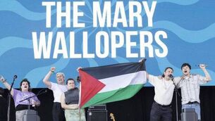 <p>The Mary Wallopers stand in defiance after they were told to remove their Palestinian Flag at the Victorious Festival in Portsmouth</p>