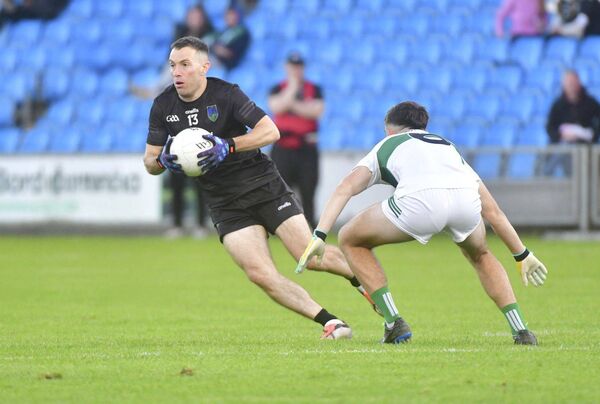 Courtwood's Niall Donoher gives Portlaoise's Ben Dempsey the slip in their Senior Football Championship quarter-final win	Photo: Denis Byrne