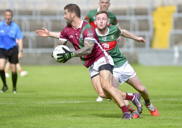 Portarlington's Jason Moore turning to get past Graigucullen's Jack Byrne in the SFC semi-final on Sunday Photo: Denis Byrne