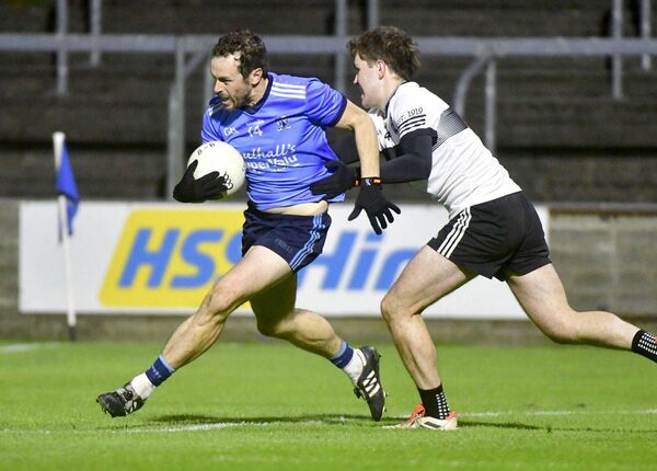 Ballyroan Abbey's Padraig McMahon drives past Barrowhouse's Josh Deveraux in the JFC final Photo: Denis Byrne