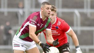 <p>Robbie Pigott (Portarlington) with Matthew Byron (Courtwood) moving in to challenge Photo: Denis Byrne</p>