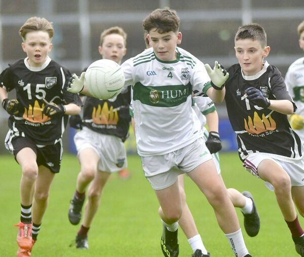 Harry Marum (Portlaoise) looking to break out of defence with Na Fianna Óg players giving chase Photo: Denis Byrne Harry Marum (Portlaoise) looking to break out of defence with Na Fianna Óg players giving chase Photo: Denis Byrne