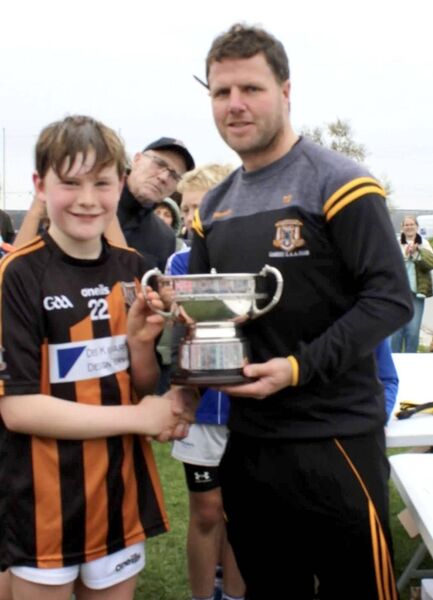 Tadhg Doran presents the trophy to Ben Molloy, winning captain on the day Tadhg Doran presents the trophy to Ben Molloy, winning captain on the day