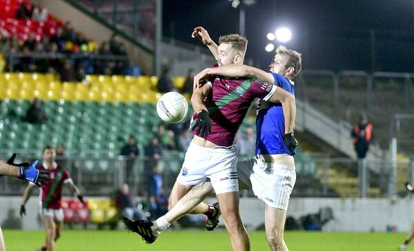 Eoin McCann (Portarlington) and Ian Atkinson (Old Leighlin) get in a tangle battling for this ball Photo: Denis Byrne Eoin McCann (Portarlington) and Ian Atkinson (Old Leighlin) get in a tangle battling for this ball Photo: Denis Byrne
