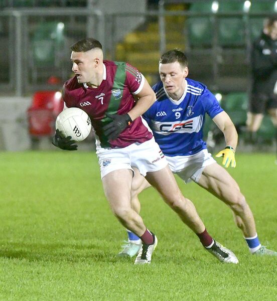 Paddy O'Sullivan (Portarlington) turns to break from Mikey Bambrick (Old Leighlin) Photo: Denis Byrne