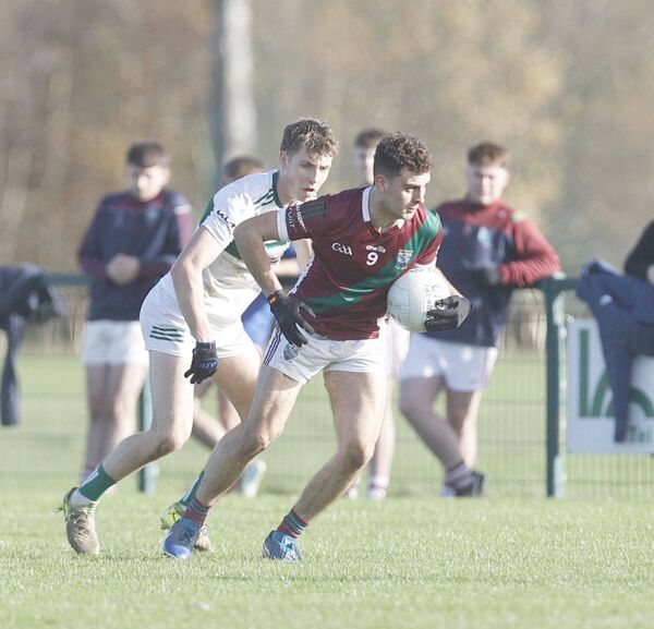 Hugo Emerson (Portarlington) gets away from Darren Brennan (Portlaoise) in their U/20FC game Photo: David Maher