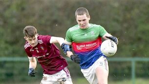 <p>Cormac Deegan (Stradbally Parish Gaels) breaking with Conor George (Na Fianna Óg) challenging Photo: Denis Byrne</p>