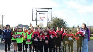<p>Fifth class pupils on the new basketball court at Timahoe NS</p>
