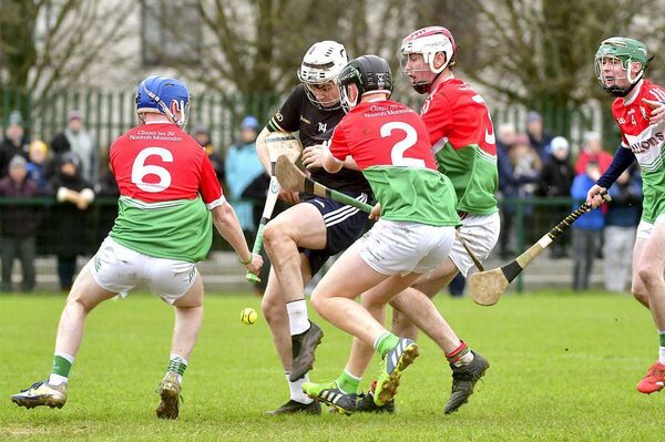 Clan na nGael's Jimmy Norton battles to get out of this tight corner in the U/20HC 'B' final Photo: Denis Byrne Clan na nGael's Jimmy Norton battles to get out of this tight corner in the U/20HC 'B' final Photo: Denis Byrne