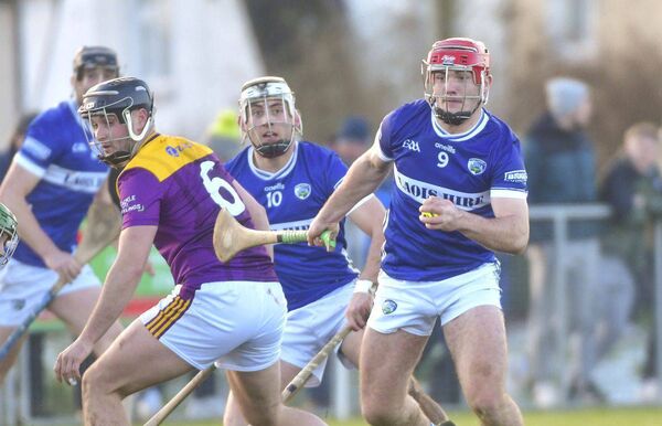 David Dooley (Laois) breaks away from these Wexford players on Sunday Photo: Denis Byrne