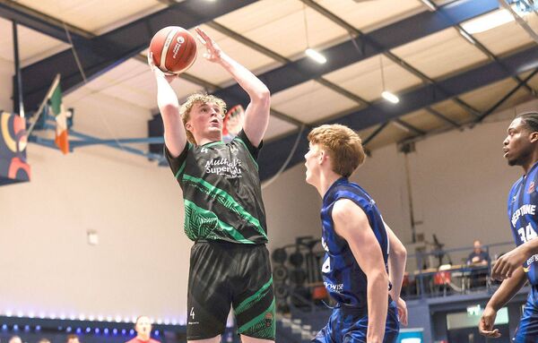 Portlaoise Panthers' Luke Kavanagh is challenged by Ben O'Connell of Neptune as he goes for the basket Photo: ©INPHO/Tom Maher