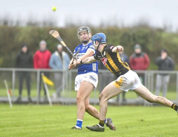 Laois's Eoghan Murphy gets his shot away despite the attention of Kilkenny's Cathal Beirne Photo: Denis Byrne