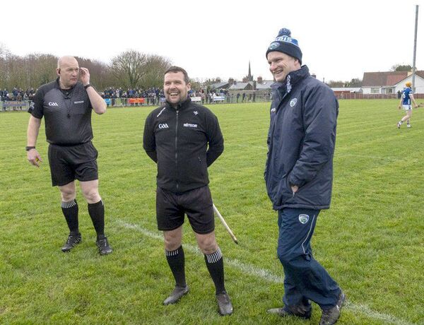Tommy Fitzgerald shares a joke with the officials before the game in Rathdowney Photo: Denis Byrne