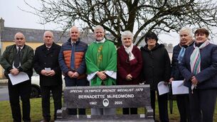<p>Fr Brian Griffin PP with the McRedmond family at the unveiling of the Bernadette McRedmond bench in Castletown. Photos: James Fennelly</p>