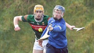 <p>Laois goalkeeper Cathal Dunne gets his pass away despite the close attention of Mayo's Cormac Phillips during the National Hurling League Division 2 Rd 1 tie at Adrian Freeman Memorial Park, Tooreen, last Sunday. Photo: David Farrell Photography </p>