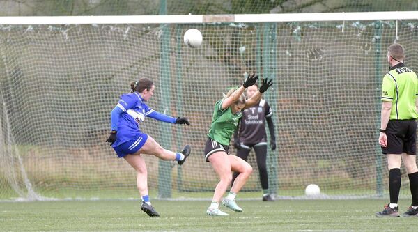 Kelly O'Neill lands a point for Laois despite the best efforts of Fermanagh's Brenda Bannon to deny her in their National League game Photo: Denis Byrne