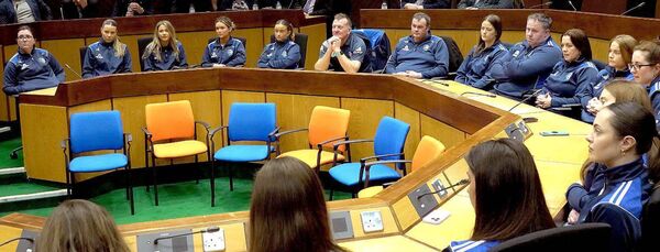 Team members and officials in the Council Chamber