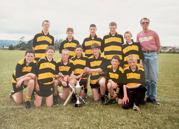 Michael Dowling with one of the earlier Heath rounders team he trained