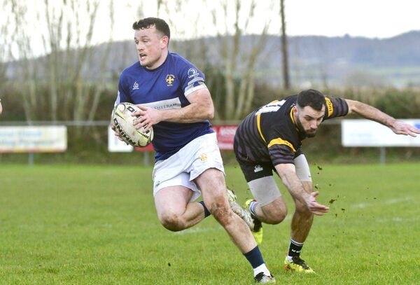 Bryan Croke dodges this tackle on his way to scoring a try for Portlaoise on Sunday Photo: Denis Byrne