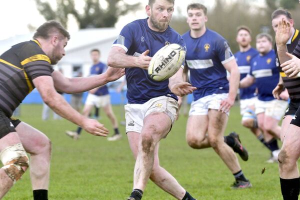 Portlaoise's Kevin Griffin makes this pass as contact is incoming Photo: Denis Byrne