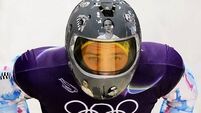 IOC urges Ukrainian racer to compete amid row over banned war victim helmet