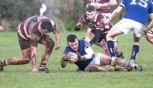 Bryan Croke (Portlaoise) tidies up this ball as two Portarlington players are about to pounce Photo: Denis Byrne