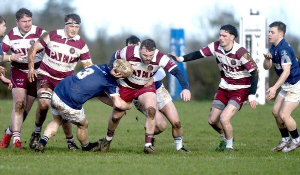 Portlaoise's Aran Coiley goes in low and hard on Portarlington's Jordan Fitzpatrick Photo: Denis Byrne