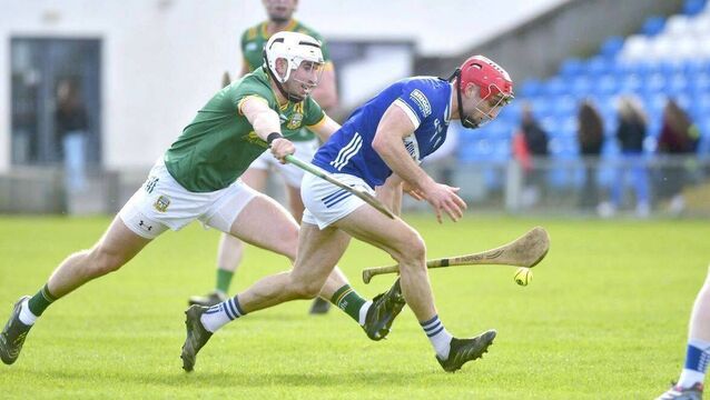 <p>Jack Kelly (Laois) gathers the the sliotar with Simon Ennis (Meath) on his heels 	Photo: Denis Byrne</p>